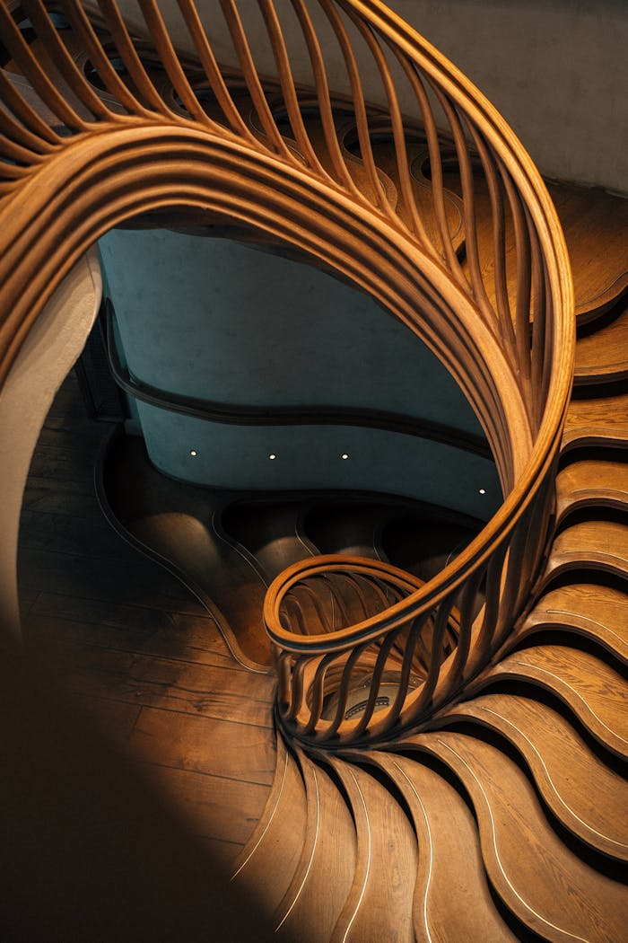 gallery-1 A mesmerizing spiral staircase featuring elegant wooden balustrades in a modern London interior.